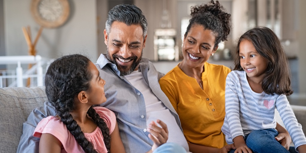 happy joyful mixed race family having fun together